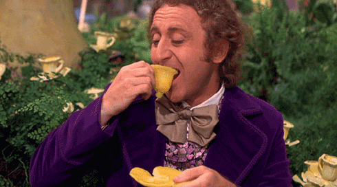 Willy Wonka eating an edible cup, and holding an edible plate